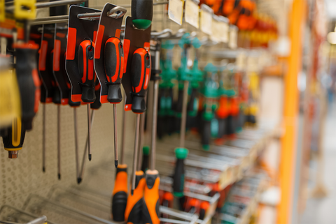 This is a picture of a variety of hardware tools on display at Farmer's Association, a farm supply store in Central Arkansas. The shelves are stocked with a range of tools, from hammers and screwdrivers to hoes and shovels.